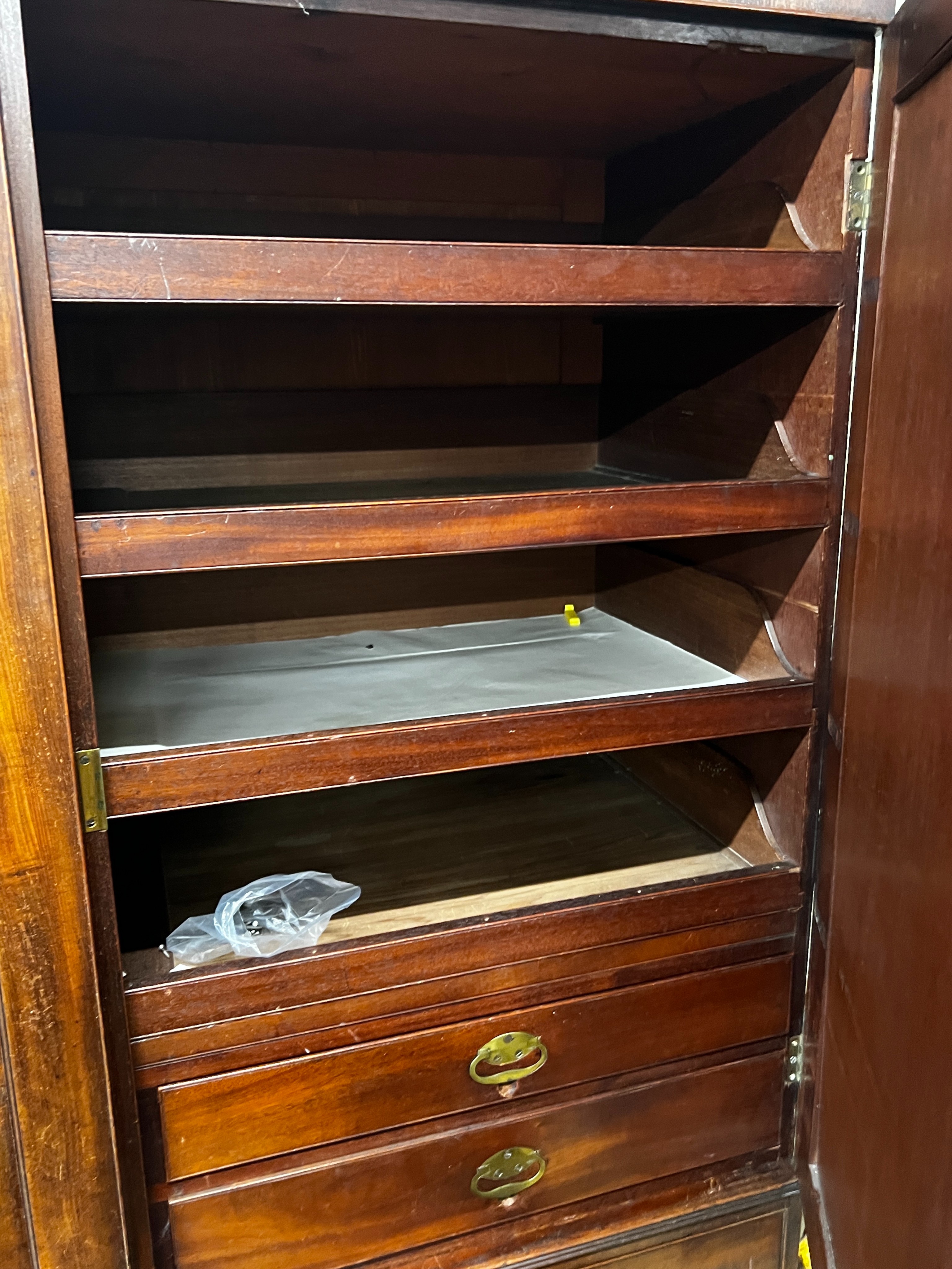 A late 18th century mahogany compactum wardrobe, fitted with three flame mahogany doors, length 217cm, depth 59cm, height 188cm